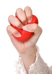 Hands of a woman squeezing a stress ball