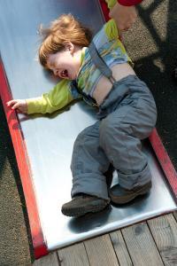 Stubborn naughty boy crying on the playground