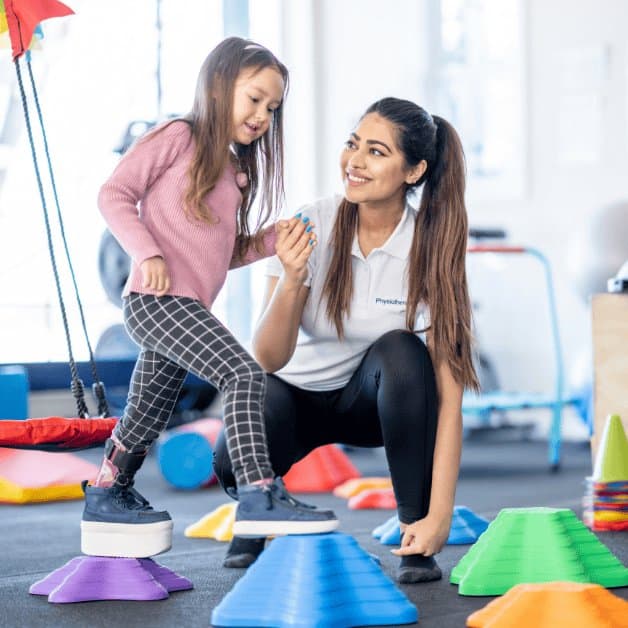 Young girl wearing modified sneakers working with an occupational therapist